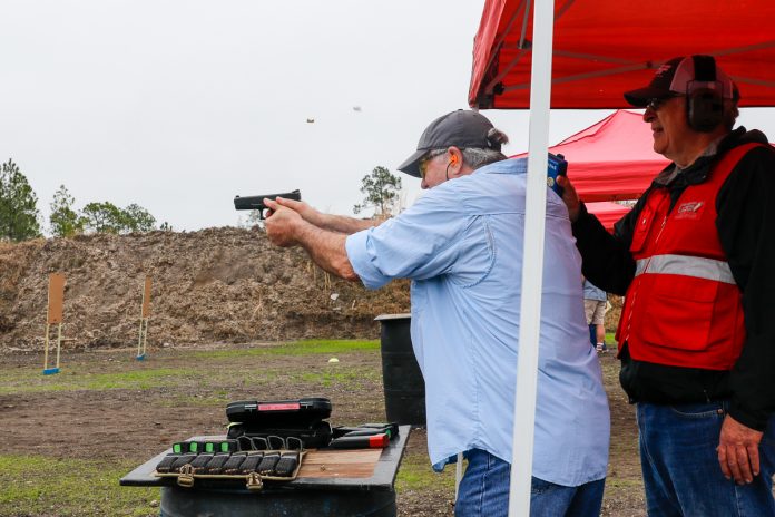 Master shooter Steve Sager double taps a target. Two spent casings in air, gun still level show speed and skill.